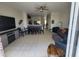 Open concept living room and kitchen space with tile flooring and ceiling fan at 2407 Silver Palm Dr, Kissimmee, FL 34747