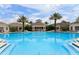 Community pool with surrounding lounge chairs and palm trees at 2407 Silver Palm Dr, Kissimmee, FL 34747