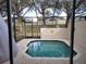 Inviting in-ground pool surrounded by screened enclosure, providing privacy and a relaxing outdoor oasis at 2407 Silver Palm Dr, Kissimmee, FL 34747