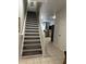 Staircase with wood-look risers and carpet at 2407 Silver Palm Dr, Kissimmee, FL 34747