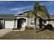 Inviting exterior of a single-story home with a palm tree and well-maintained lawn at 241 Shady Ln, Deland, FL 32724