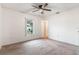 Spacious bedroom with neutral decor, large window and ceiling fan at 2752 Sedgefield Ave, Deltona, FL 32725