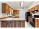 Galley kitchen with wood cabinets, black appliances, and a breakfast bar at 2752 Sedgefield Ave, Deltona, FL 32725