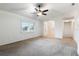 Bright living room with neutral walls, ceiling fan, and view to entryway at 2752 Sedgefield Ave, Deltona, FL 32725