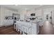 Modern kitchen with white cabinets, stainless steel appliances, and kitchen island at 2924 Moulin Rd, Davenport, FL 33837