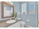 Small bathroom with a vanity, toilet, and a small window at 303 Foxhill Ct, Debary, FL 32713