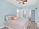 Light blue bedroom with a queen bed, ensuite bathroom, and walk-in closet at 303 Foxhill Ct, Debary, FL 32713