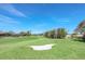 Lush green fairways and sand traps on a sunny day at 303 Foxhill Ct, Debary, FL 32713