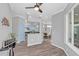 Bright and spacious living room with wood-look floors and large windows at 303 Foxhill Ct, Debary, FL 32713