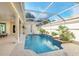 Inviting screened-in pool with a waterfall feature at 303 Foxhill Ct, Debary, FL 32713