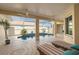 Relaxing pool area with striped lounge chairs under a covered patio at 303 Foxhill Ct, Debary, FL 32713