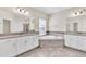 Elegant bathroom featuring a corner soaking tub and double vanities at 3138 Dark Sky Dr, Harmony, FL 34773