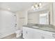 Bathroom with granite countertop, white cabinets, and a bathtub at 3138 Dark Sky Dr, Harmony, FL 34773