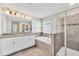 Double vanity bathroom with walk-in shower and bathtub at 3138 Dark Sky Dr, Harmony, FL 34773