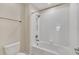 Clean bathroom with a shower/tub combo and neutral tile at 3138 Dark Sky Dr, Harmony, FL 34773