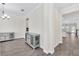 A view down a hallway showcasing an open floor plan and gray flooring at 3138 Dark Sky Dr, Harmony, FL 34773