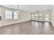 Bright and airy living room with wood-look flooring at 3138 Dark Sky Dr, Harmony, FL 34773