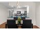 Dining area with a glass table and black chairs, near kitchen at 3163 Britannia Blvd # D, Kissimmee, FL 34747