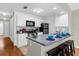 Modern kitchen with white cabinets, black appliances, and a breakfast bar at 3163 Britannia Blvd # D, Kissimmee, FL 34747