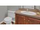 Powder room with wood cabinets, laminate countertop, and a modern faucet at 370 Aldershot Ct, Kissimmee, FL 34758