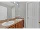 Bathroom with double sinks and wood cabinets at 370 Aldershot Ct, Kissimmee, FL 34758