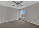 A cozy bedroom with neutral walls, plush carpeting, and a ceiling fan for optimal comfort at 370 Aldershot Ct, Kissimmee, FL 34758