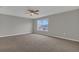 This bedroom features neutral walls, cozy carpeting, and a ceiling fan for added comfort at 370 Aldershot Ct, Kissimmee, FL 34758