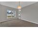 This dining room features neutral paint, a pendant light, and plush carpeting at 370 Aldershot Ct, Kissimmee, FL 34758