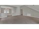 Open living area with gray walls, neutral carpet, and a view to the dining area at 370 Aldershot Ct, Kissimmee, FL 34758