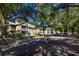 Two-story apartment featuring screened-in balconies, parking, and mature trees at 3721 S Lake Orlando Pkwy # 2, Orlando, FL 32808