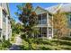 Exterior angle of a building showcasing a screened porch and garden at 3721 S Lake Orlando Pkwy # 2, Orlando, FL 32808