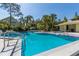 Sparkling community pool with mature trees and comfortable sun loungers at 3721 S Lake Orlando Pkwy # 2, Orlando, FL 32808