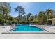 Sparkling community pool with mature trees and comfortable sun loungers at 3721 S Lake Orlando Pkwy # 2, Orlando, FL 32808