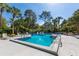 Sparkling community pool with mature trees and comfortable sun loungers at 3721 S Lake Orlando Pkwy # 2, Orlando, FL 32808