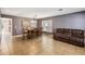 Spacious dining area with a wooden table and brown leather couch at 3969 Lone Eagle Pl, Sanford, FL 32771