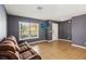 Living room with brown couch and access to the front door at 3969 Lone Eagle Pl, Sanford, FL 32771