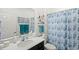 Clean bathroom with a shower/tub combo and teal accents at 3999 Night Heron Dr, Sanford, FL 32773