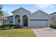 Gray house with a two-car garage and a brick paved driveway at 3999 Night Heron Dr, Sanford, FL 32773