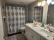 Bathroom featuring dual sinks, a vanity, tile flooring, and a shower with a curtain at 400 Auburn Dr # 3, Daytona Beach, FL 32118