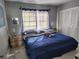 Bedroom with a bed with blue bedding, side tables, and a window at 400 Auburn Dr # 3, Daytona Beach, FL 32118