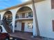 Exterior view of a condo featuring an entryway beneath an arched walkway and balcony at 400 Auburn Dr # 3, Daytona Beach, FL 32118