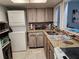 Bright kitchen featuring a washer/dryer, mosaic backsplash, granite countertops and modern appliances at 400 Auburn Dr # 3, Daytona Beach, FL 32118