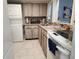 Bright kitchen featuring a washer/dryer, mosaic backsplash, granite countertops and modern appliances at 400 Auburn Dr # 3, Daytona Beach, FL 32118