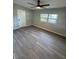 Spacious bedroom with gray flooring and ceiling fan at 4072 Shellman St, Orlando, FL 32811