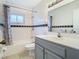 Bathroom with tub, shower, gray vanity, and tile floor at 4400 Southmore Dr, Orlando, FL 32812