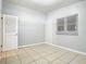 Simple bedroom with tile floors and window with blinds at 4400 Southmore Dr, Orlando, FL 32812