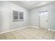 Bright room with tile flooring, a window, and exterior access at 4400 Southmore Dr, Orlando, FL 32812