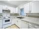 White kitchen features new countertops and appliances at 4400 Southmore Dr, Orlando, FL 32812