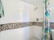 Clean shower with tile surround and patterned shower curtain at 4400 Southmore Dr, Orlando, FL 32812