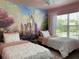 Two twin beds with ruffled bedding and a castle mural at 4560 Yellowgold E Rd # 108, Kissimmee, FL 34746